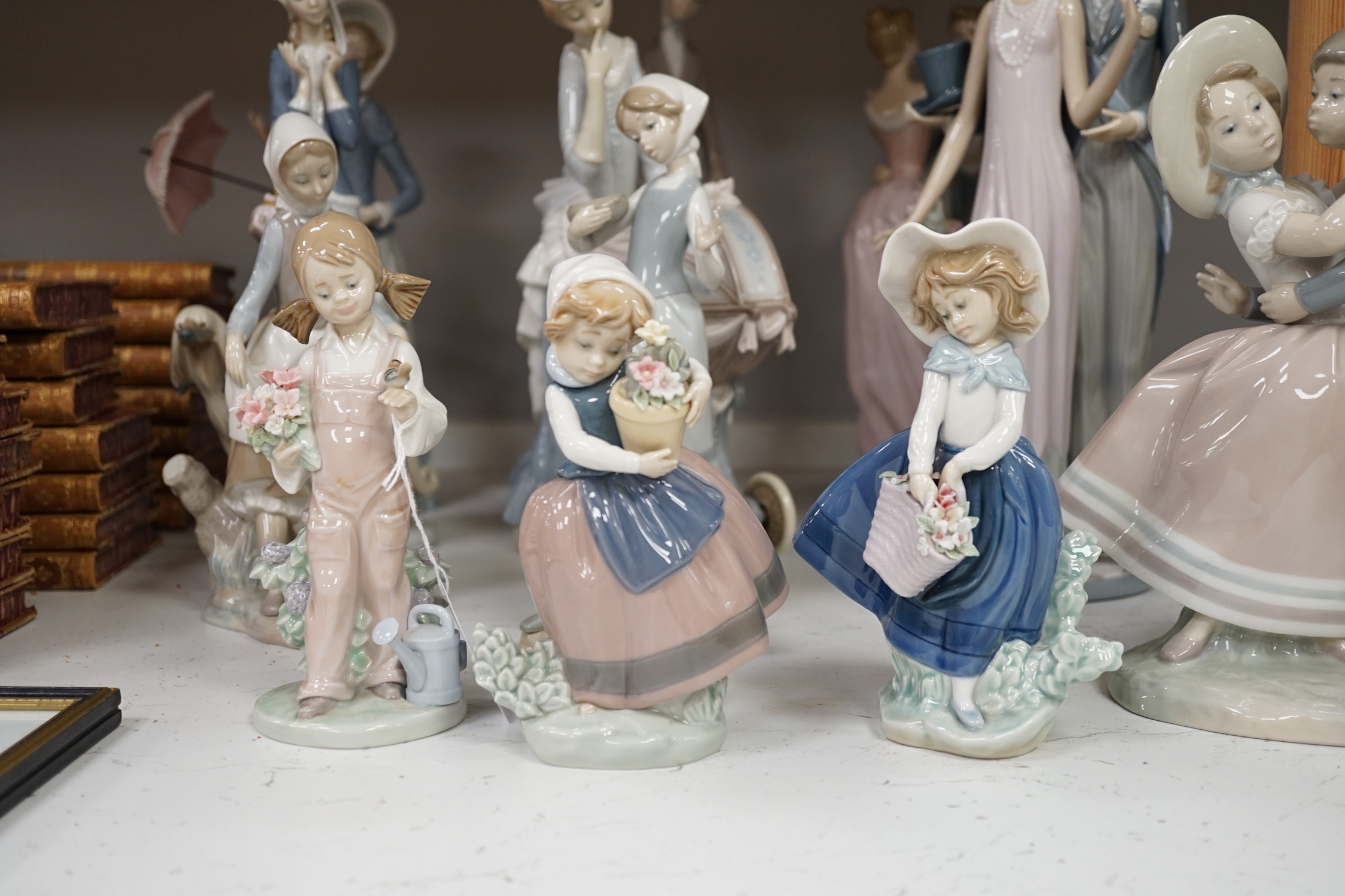 Collection of twelve Lladro figures including Precious Love and High Society